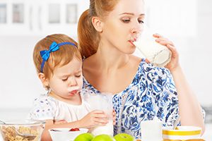 Young Mother Drinking Milk