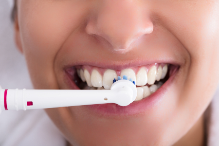 Woman with Electric Toothbrush