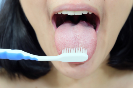 Woman Brushing Tongue